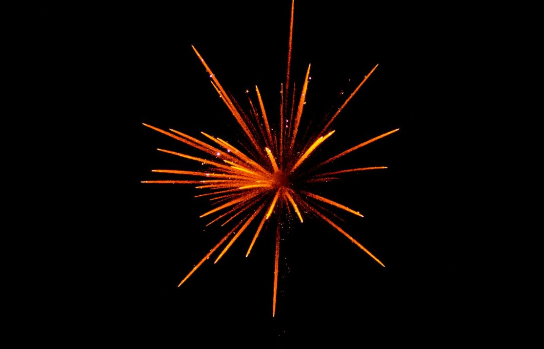 red and orange fireworks in black background